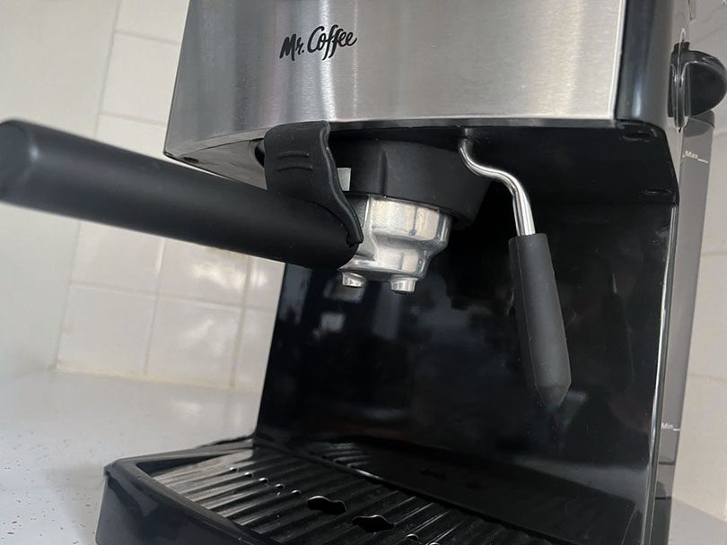 Looking up at the portafilter and branding on the Mr Coffee ECMP50 espresso machine
